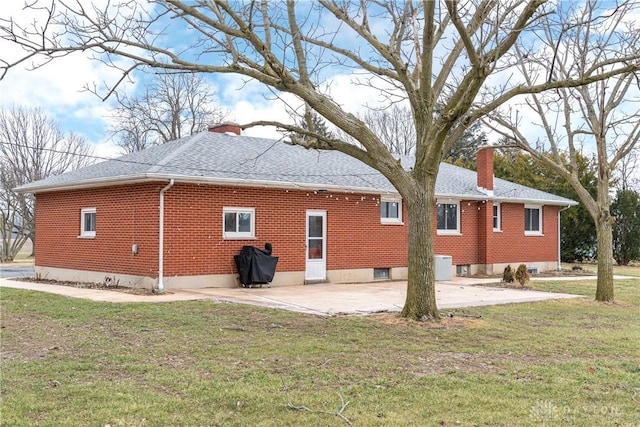 rear view of house featuring a yard and a patio area