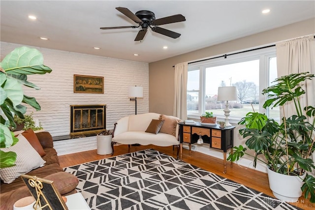 living room featuring hardwood / wood-style floors and ceiling fan