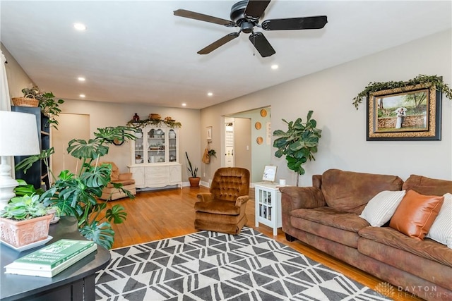 living room with ceiling fan and hardwood / wood-style floors