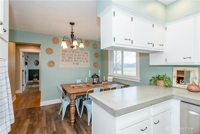 kitchen with white cabinetry, hanging light fixtures, stainless steel dishwasher, and kitchen peninsula