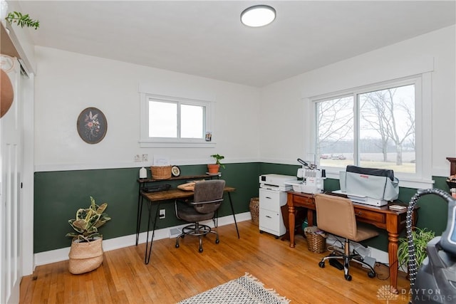 office space with a healthy amount of sunlight and light wood-type flooring