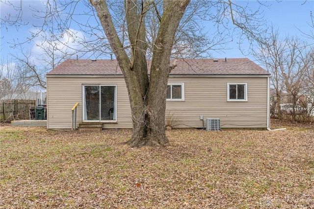 rear view of property with a yard and cooling unit