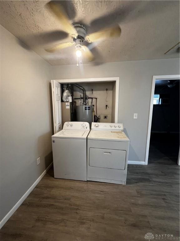 laundry area with dark wood finished floors, laundry area, baseboards, and separate washer and dryer