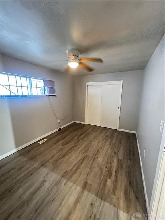 unfurnished bedroom with visible vents, a textured ceiling, and wood finished floors