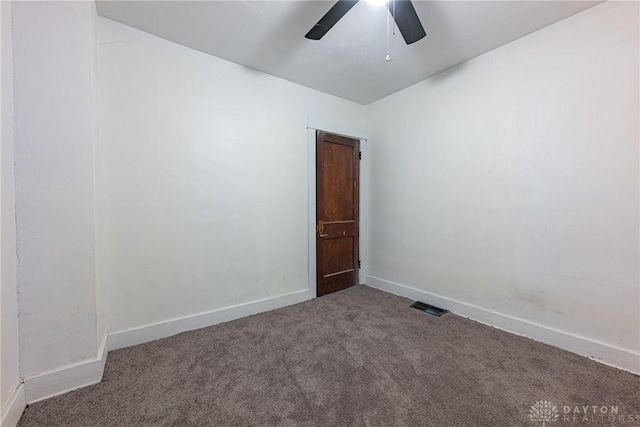 carpeted spare room with ceiling fan