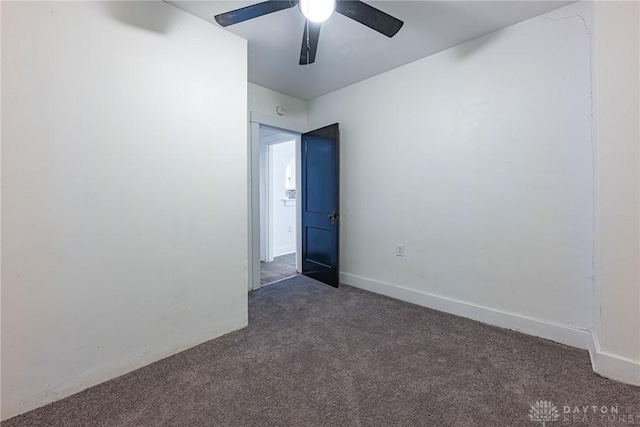 unfurnished room featuring dark colored carpet