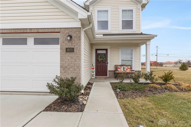 1605 Ashbury Ct, Franklin, OH 45005 - doorway to property featuring a porch, an attached garage, and brick siding