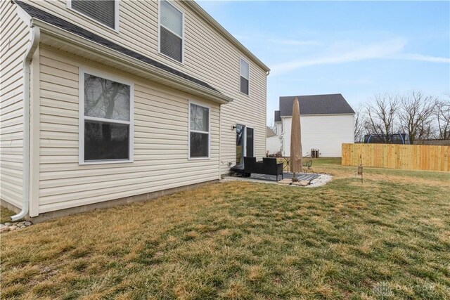 1605 Ashbury Ct, Franklin, OH 45005 - view of side of home with a yard, a patio, and fence