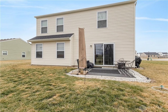 rear view of property featuring a lawn and a patio area