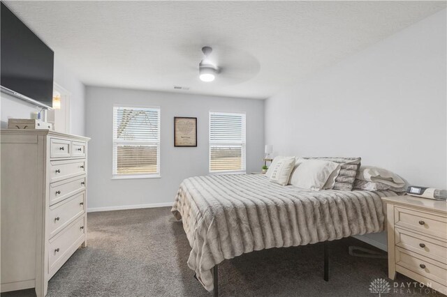 1605 Ashbury Ct, Franklin, OH 45005 - bedroom featuring visible vents, baseboards, ceiling fan, a textured ceiling, and dark carpet