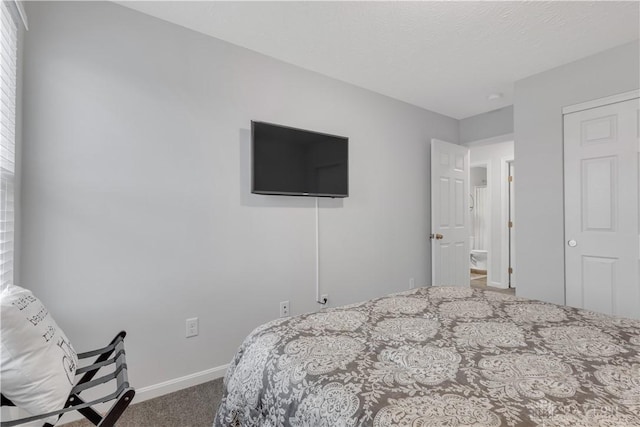 carpeted bedroom featuring a textured ceiling