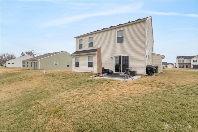 rear view of house with a lawn and a patio area