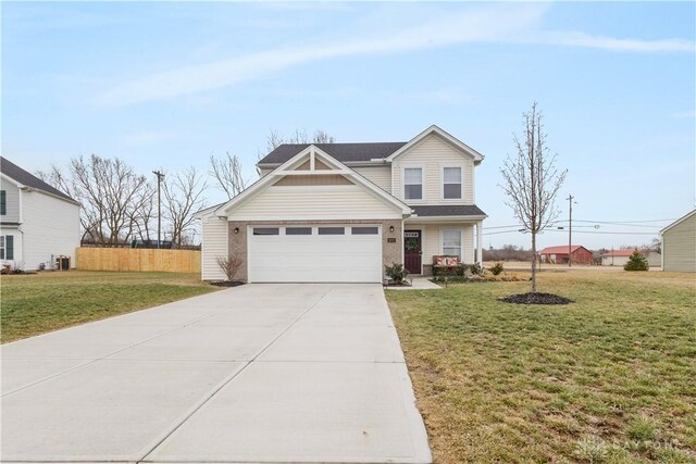 1605 Ashbury Ct, Franklin, OH 45005 - view of front facade featuring concrete driveway, fence, and a front lawn