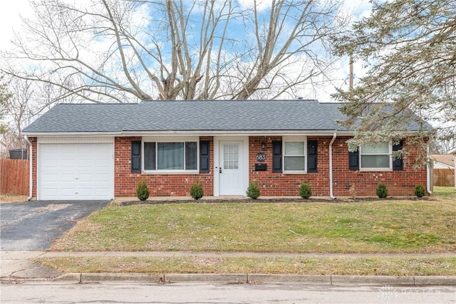 ranch-style house with a garage and a front lawn