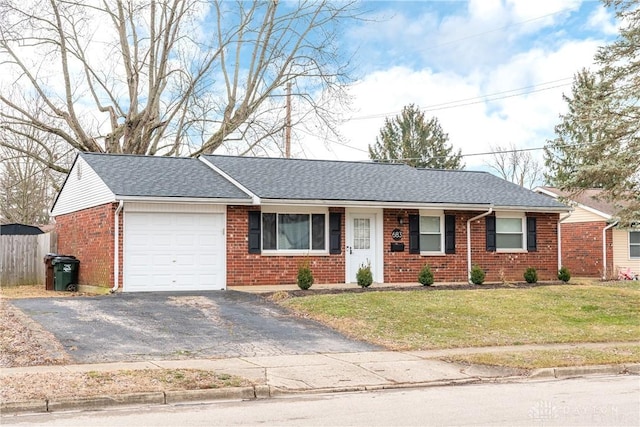 single story home with a garage and a front lawn