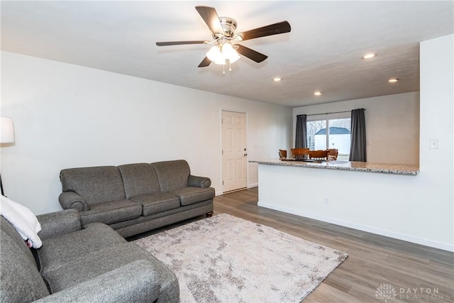 living room featuring dark hardwood / wood-style floors and ceiling fan