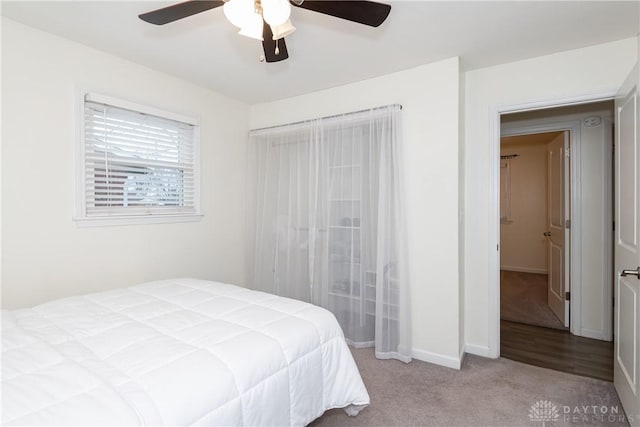 bedroom with ceiling fan and light carpet