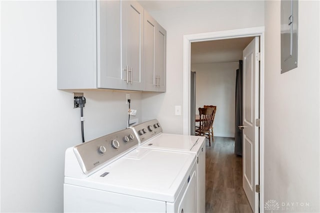 washroom featuring dark wood-type flooring, cabinets, and washer and dryer