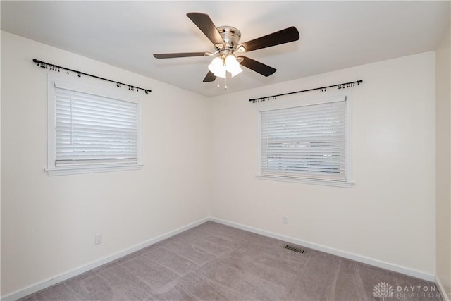 carpeted spare room with ceiling fan