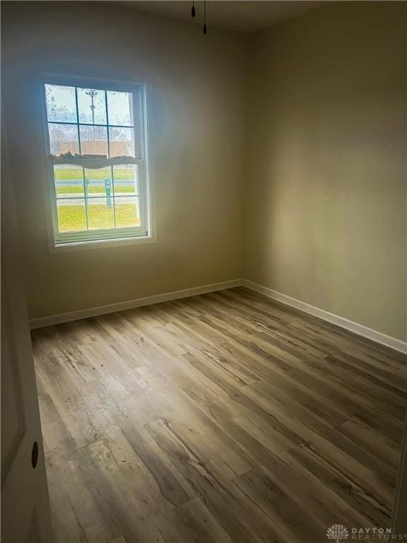 empty room with hardwood / wood-style floors