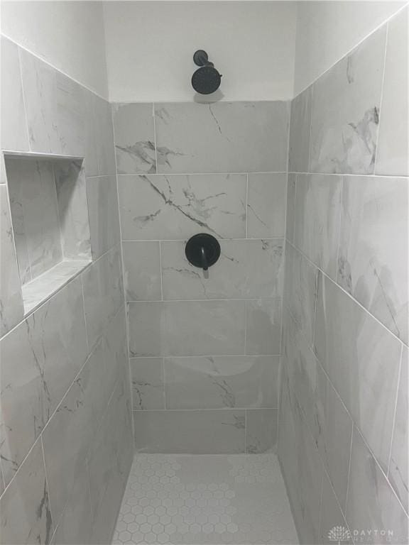 bathroom with a tile shower