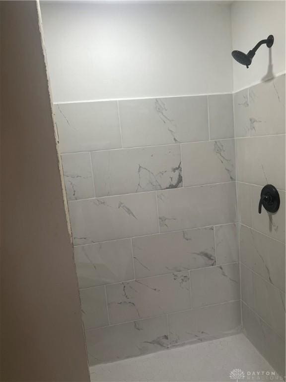 bathroom with tiled shower