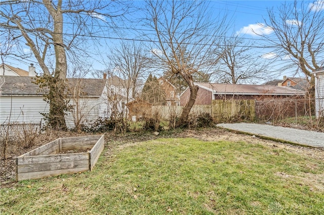 view of yard with fence and a garden