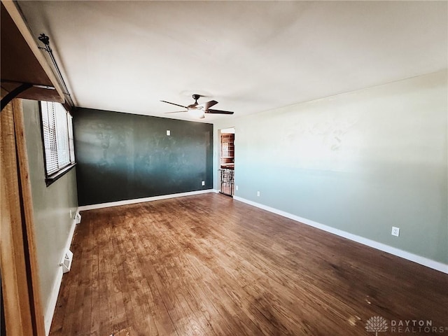 unfurnished room featuring hardwood / wood-style floors and ceiling fan