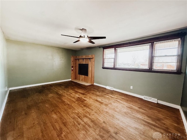 unfurnished living room featuring hardwood / wood-style flooring and ceiling fan