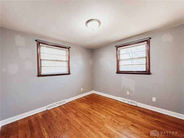 unfurnished room with light wood-type flooring