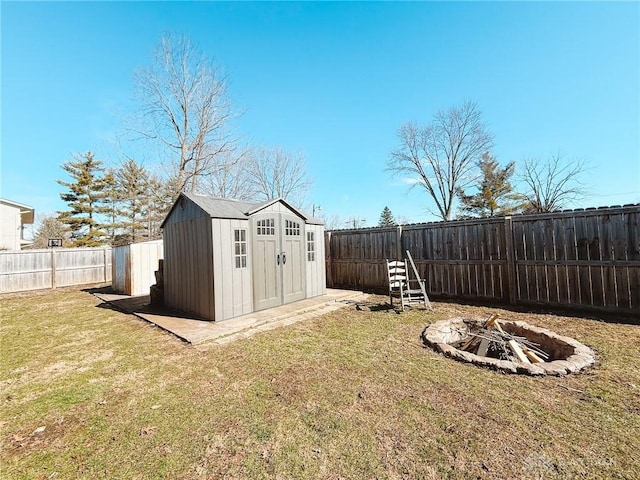 view of yard featuring a storage unit and a fire pit