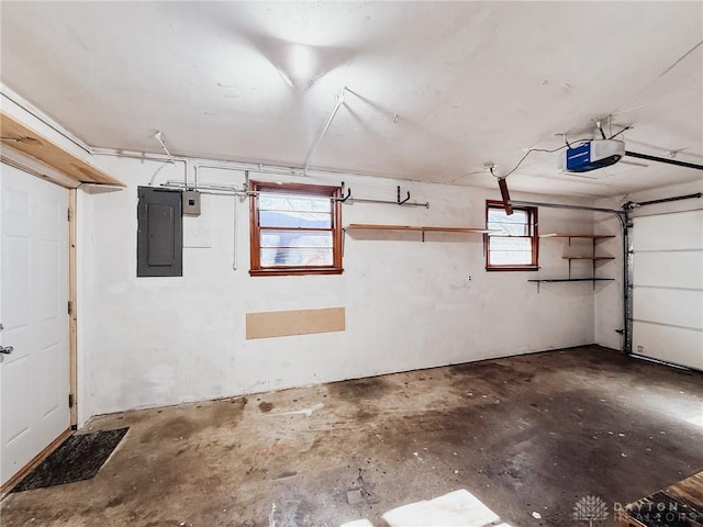 garage with a garage door opener and electric panel