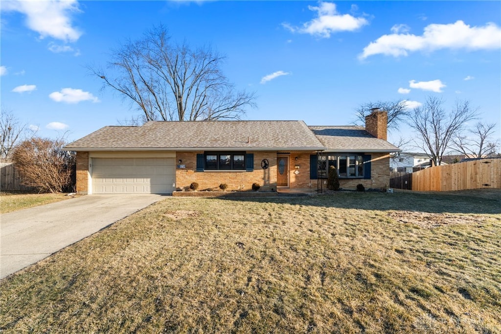 single story home featuring a garage and a front lawn