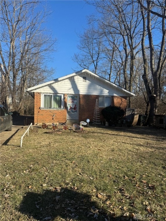 view of home's exterior with a yard and brick siding