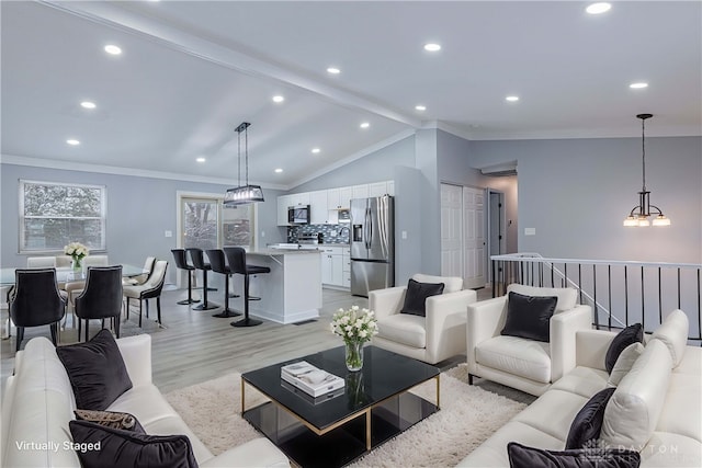 living area with crown molding, a notable chandelier, light wood-style flooring, recessed lighting, and lofted ceiling