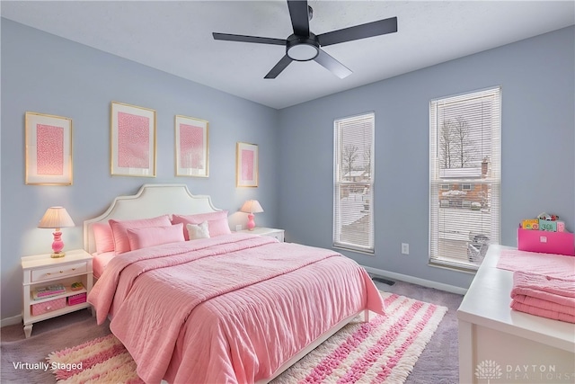 bedroom with a ceiling fan, baseboards, and carpet