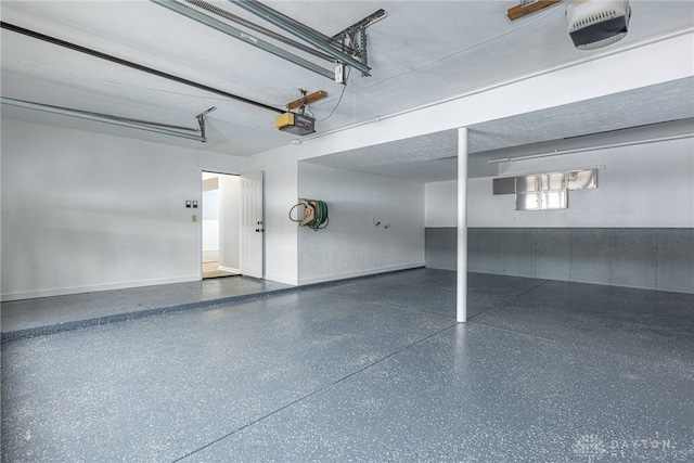 garage featuring baseboards and a garage door opener