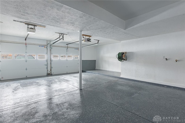 garage featuring baseboards and a garage door opener