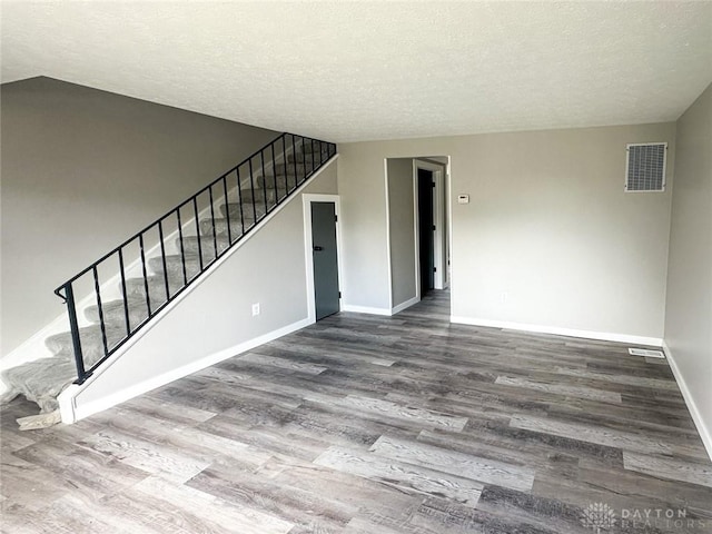 unfurnished room featuring hardwood / wood-style floors and a textured ceiling