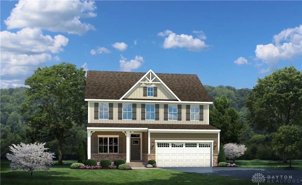 view of front of house with a garage and a front yard