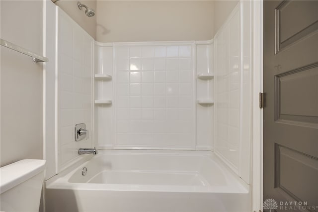 bathroom with toilet and  shower combination