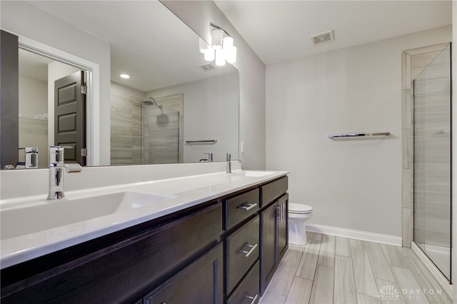 bathroom featuring vanity, toilet, and an enclosed shower