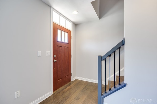 entryway with dark hardwood / wood-style flooring