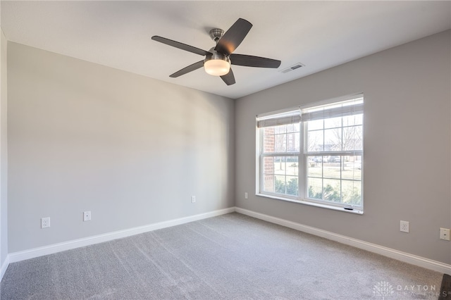 carpeted empty room featuring ceiling fan