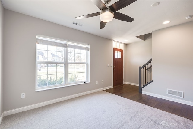 carpeted foyer with ceiling fan