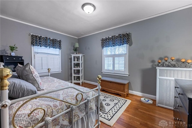 bedroom featuring hardwood / wood-style flooring and ornamental molding