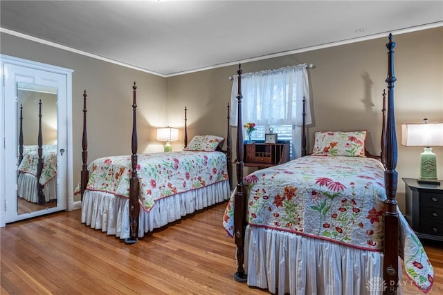 bedroom featuring hardwood / wood-style flooring and ornamental molding