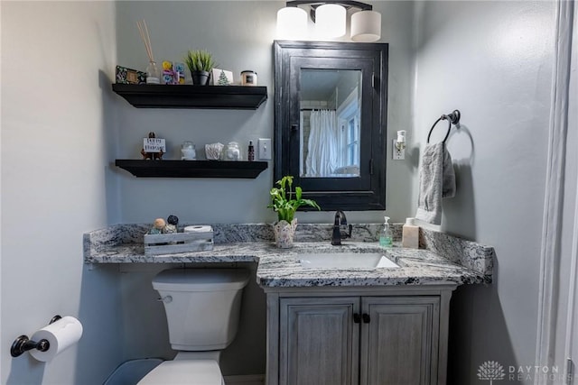 bathroom featuring vanity and toilet