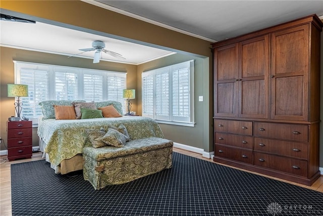 bedroom featuring crown molding, ceiling fan, and light hardwood / wood-style flooring