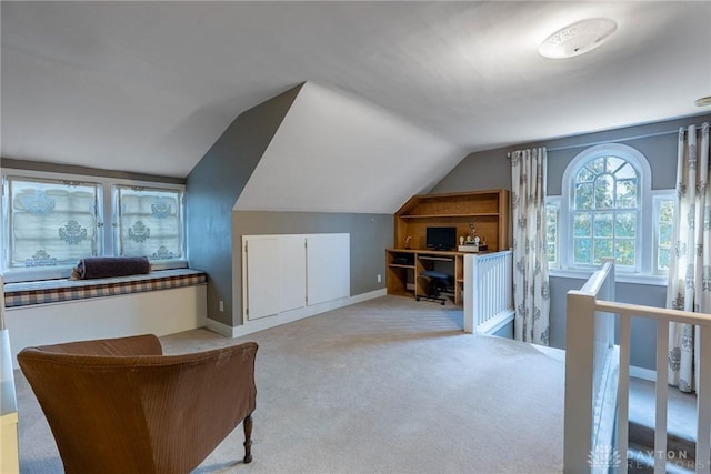 bonus room featuring vaulted ceiling and light colored carpet